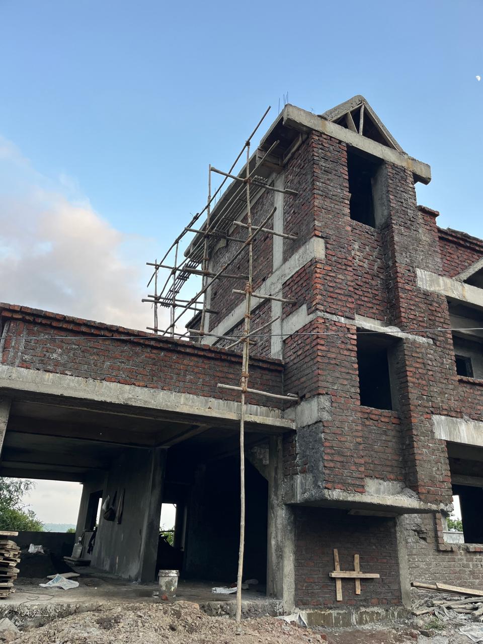 Building construction in progress with scaffolding